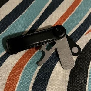 Black orbitkey with bottle opener, mirror and pin holder for sim tray/sim holder